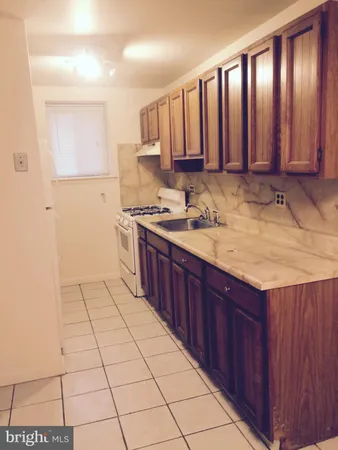 a kitchen with a sink window and cabinets