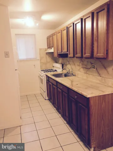 a kitchen with a sink window and cabinets