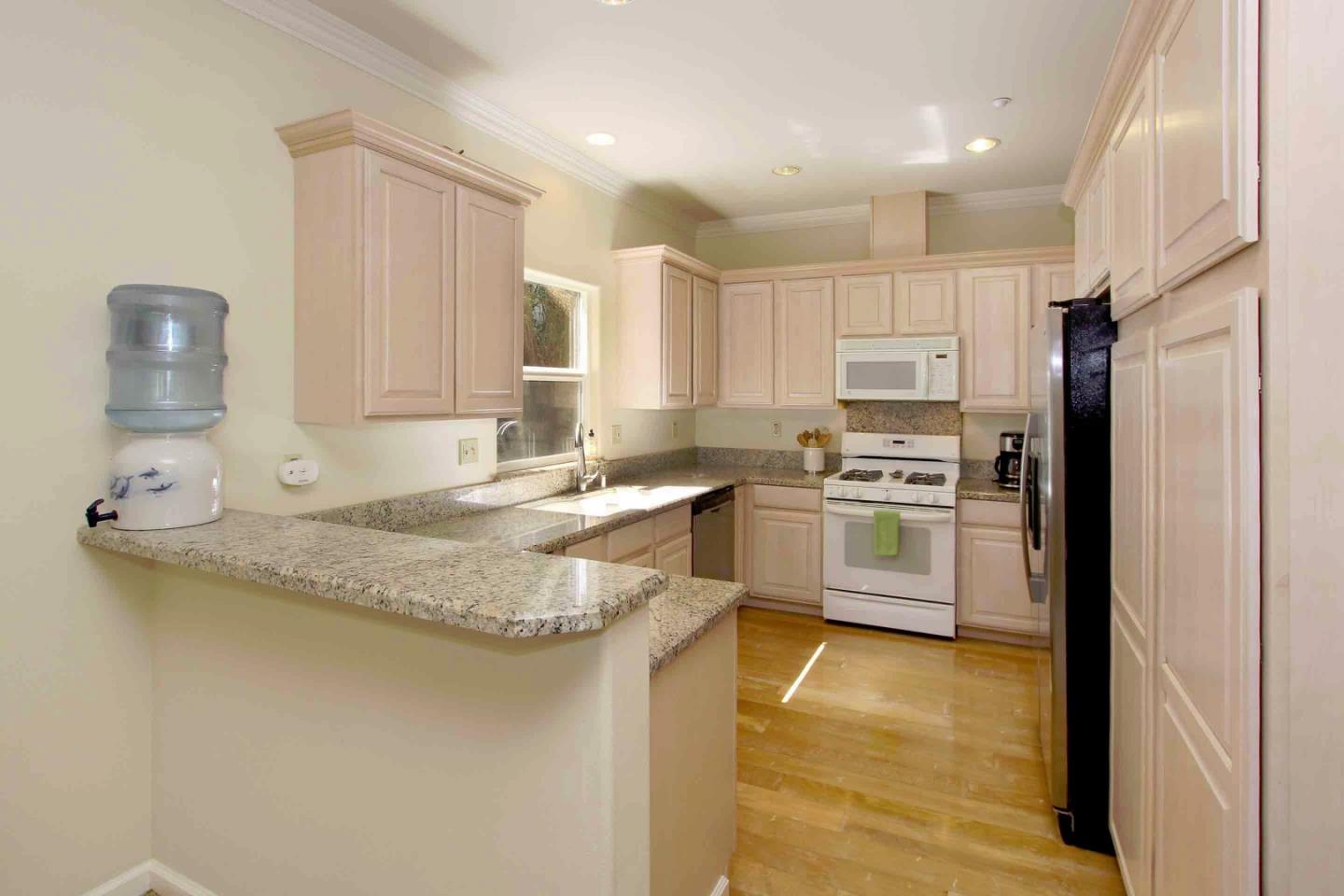 840 Seacliff Drive Aptos, CA 95003 - Photo 9 of 21 a kitchen with stainless steel appliances granite countertop a sink refrigerator and cabinets