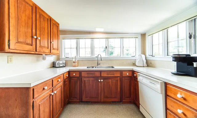 a kitchen with stainless steel appliances granite countertop a sink and a stove