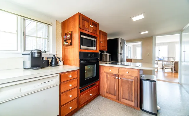 a kitchen with stainless steel appliances granite countertop a sink and cabinets