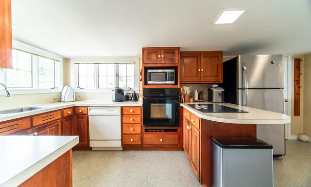 a kitchen with stainless steel appliances granite countertop a refrigerator stove and sink