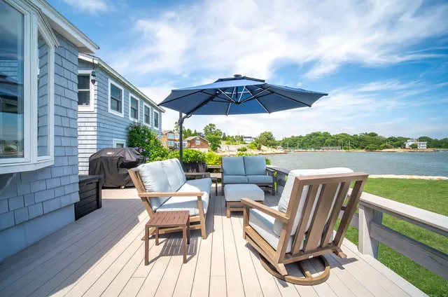 a view of a patio with a table chairs and a wooden floor