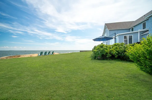 a view of a large building with big yard and large trees