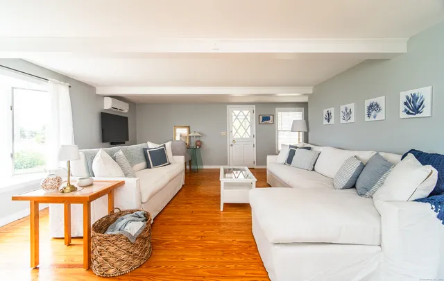 a living room with furniture a rug and a window
