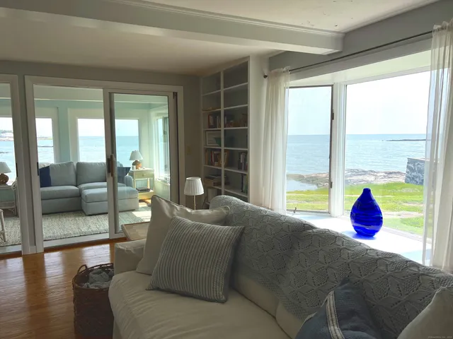a living room with furniture and floor to ceiling windows
