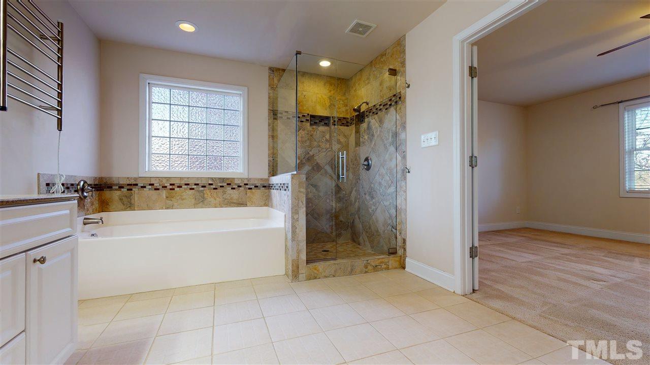 2105 Cook Road Durham, NC 27713 - Photo 14 of 29 a bathroom with a tub shower and a sink