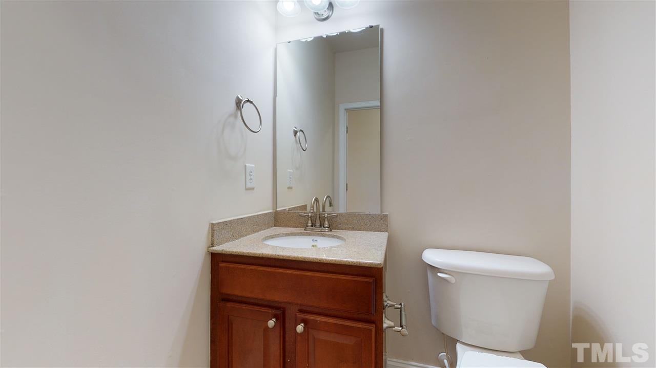 2105 Cook Road Durham, NC 27713 - Photo 19 of 29 a bathroom with a sink a toilet and mirror