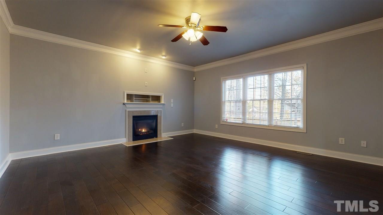 2105 Cook Road Durham, NC 27713 - Photo 21 of 29 a view of an empty room with wooden floor fireplace and a window