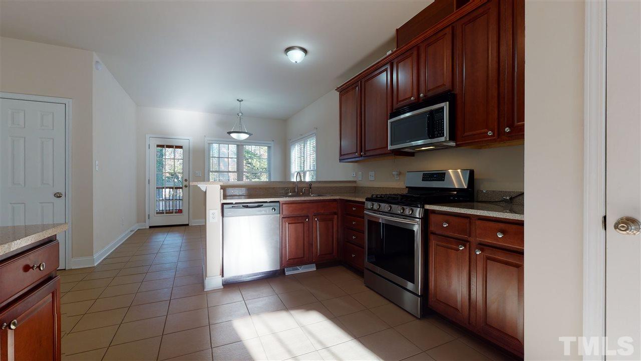 2105 Cook Road Durham, NC 27713 - Photo 26 of 29 a kitchen with stainless steel appliances granite countertop a stove a sink dishwasher and a microwave oven on the blue kitchen countertops