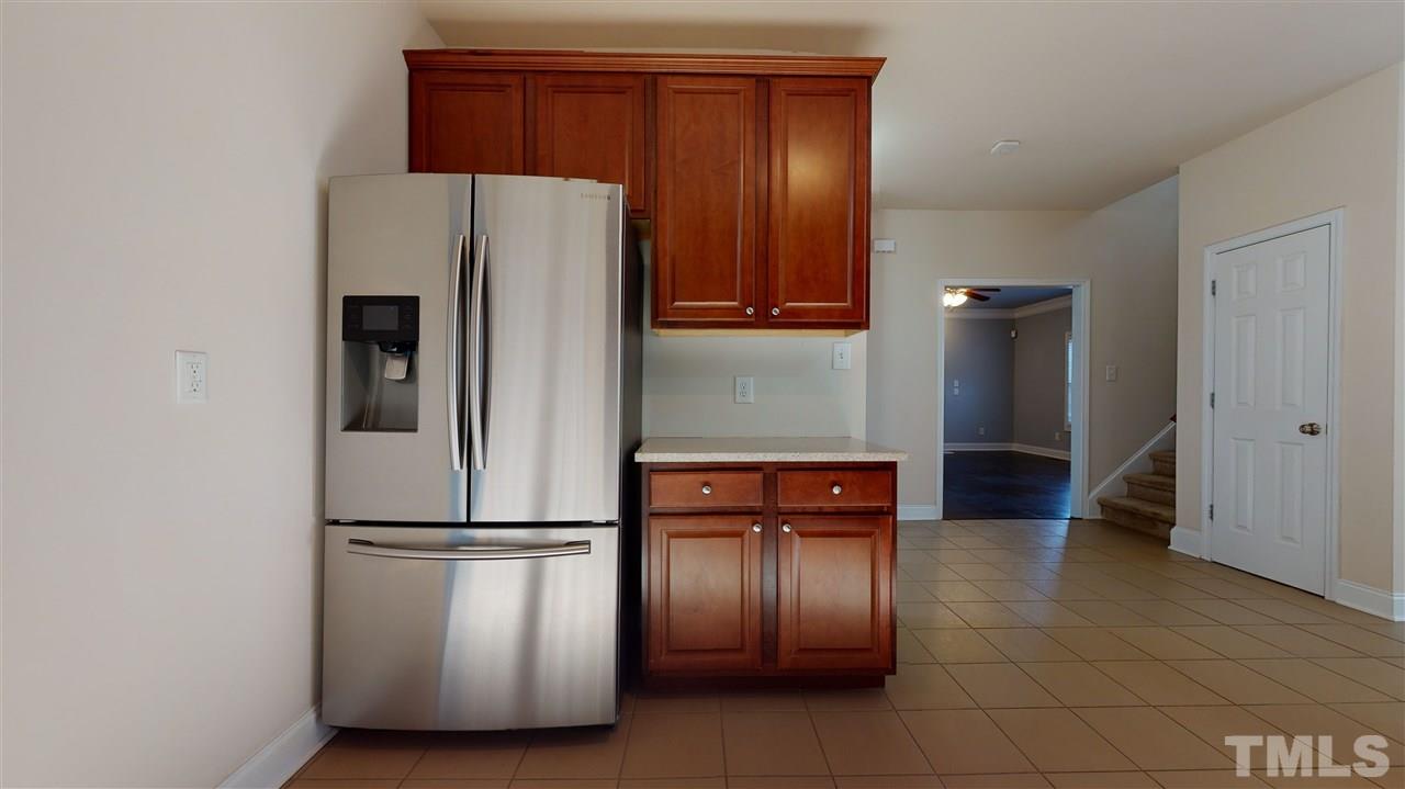 2105 Cook Road Durham, NC 27713 - Photo 27 of 29 a kitchen with stainless steel appliances granite countertop a refrigerator and a stove