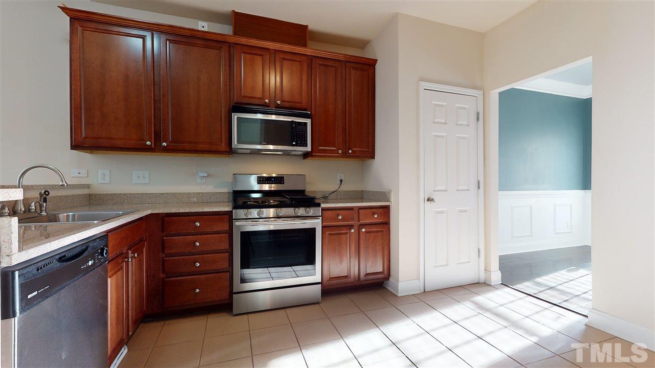 2105 Cook Road Durham, NC 27713 - Photo 29 of 29 a kitchen with stainless steel appliances granite countertop a refrigerator and a sink