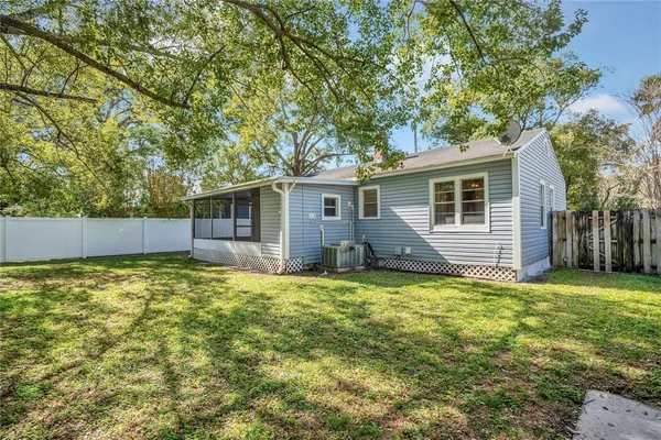 a backyard of a house with yard and outdoor seating