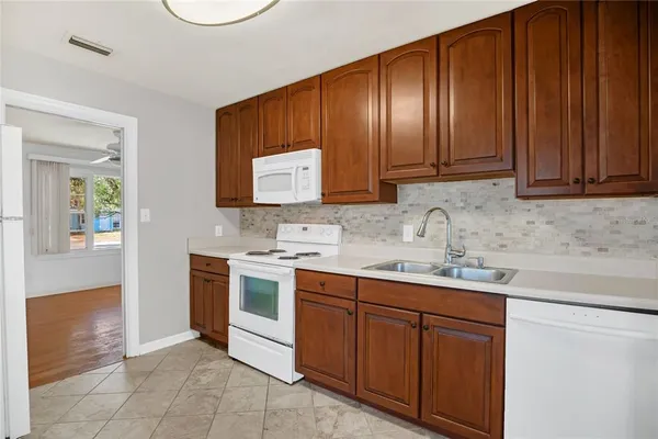 a kitchen with a sink cabinets and appliances