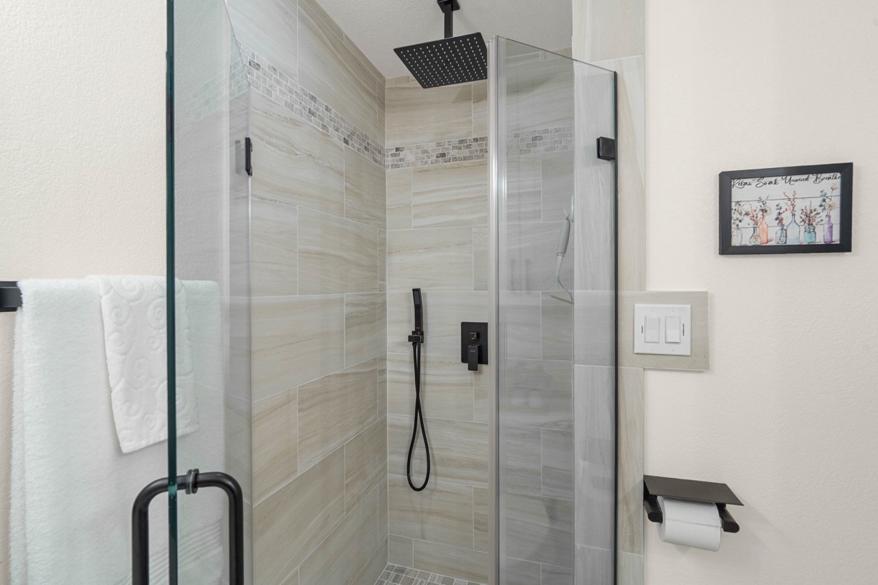 3138 Sunbeam Street Houston, TX 77051 - Photo 32 of 50 Elegant tilework, matte black fixtures, and a sleek rainfall shower head create a true everyday retreat.
