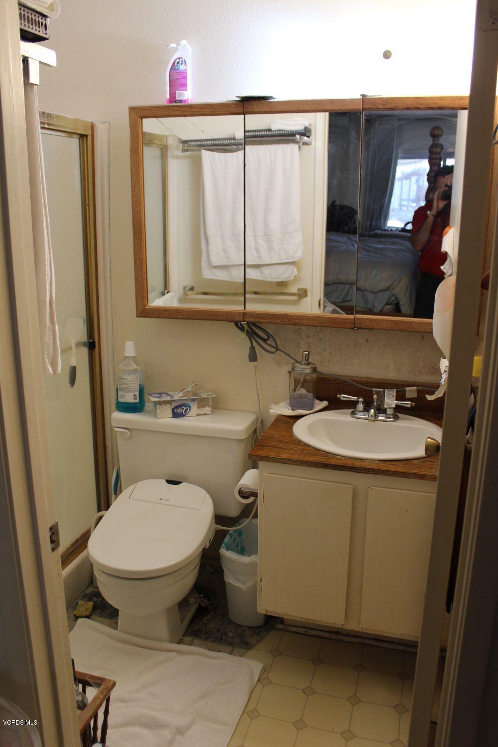 13433 Laurelhurst Road Moorpark, CA 93021 - Photo 19 of 23 a bathroom with a toilet sink and mirror