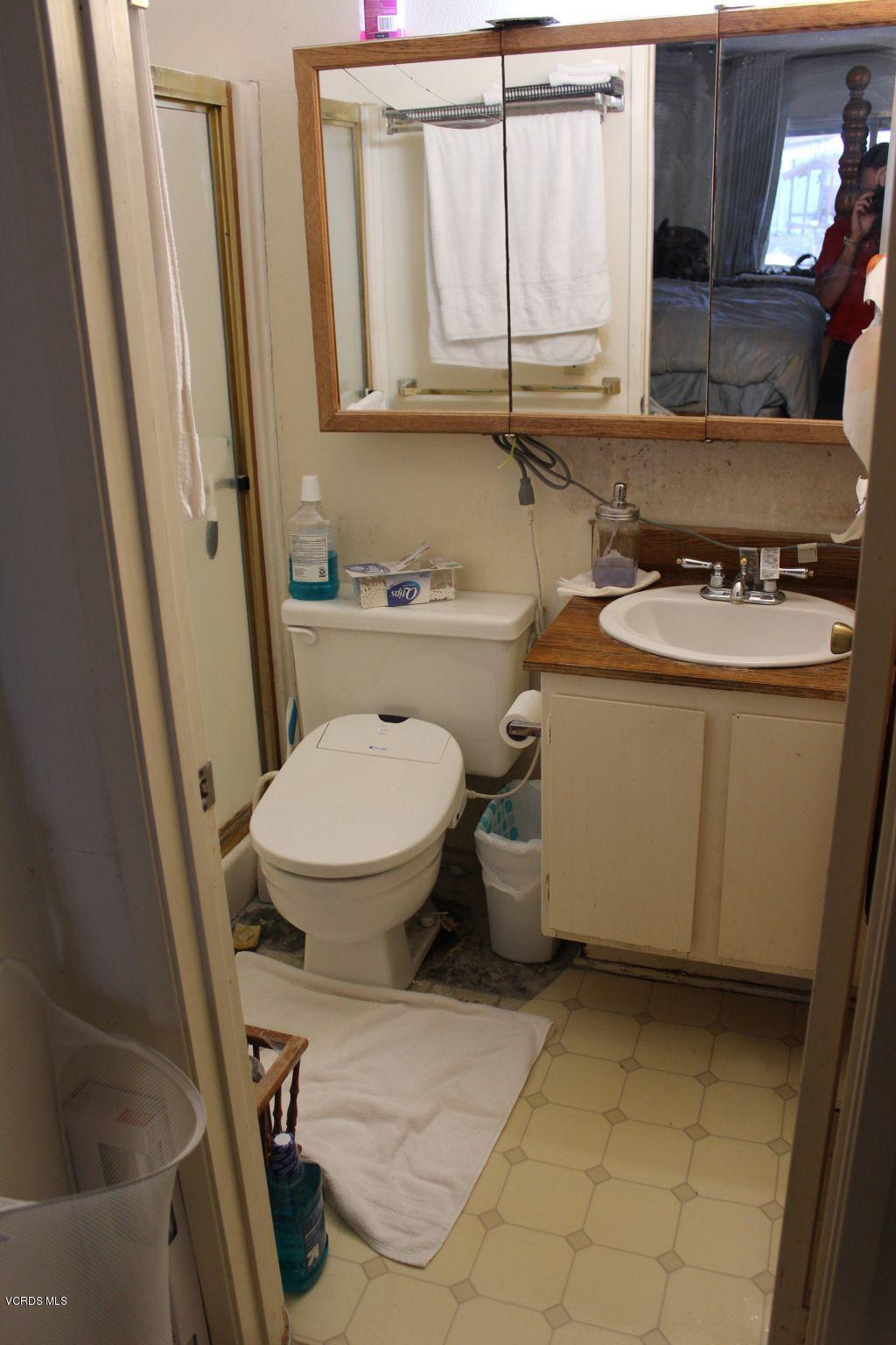 13433 Laurelhurst Road Moorpark, CA 93021 - Photo 20 of 23 a bathroom with a granite countertop toilet sink and mirror