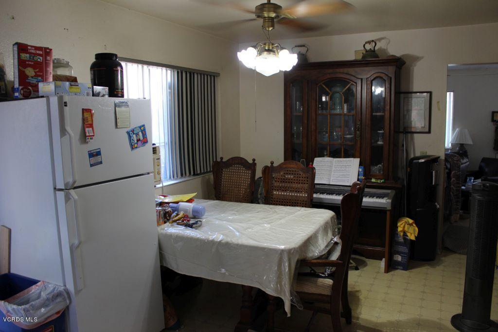 13433 Laurelhurst Road Moorpark, CA 93021 - Photo 4 of 23 a kitchen with refrigerator and dining table