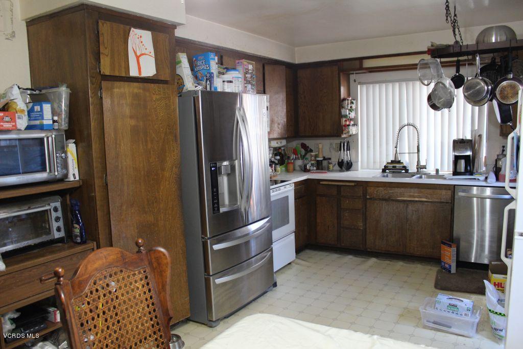 13433 Laurelhurst Road Moorpark, CA 93021 - Photo 6 of 23 a kitchen with stainless steel appliances a refrigerator and a stove