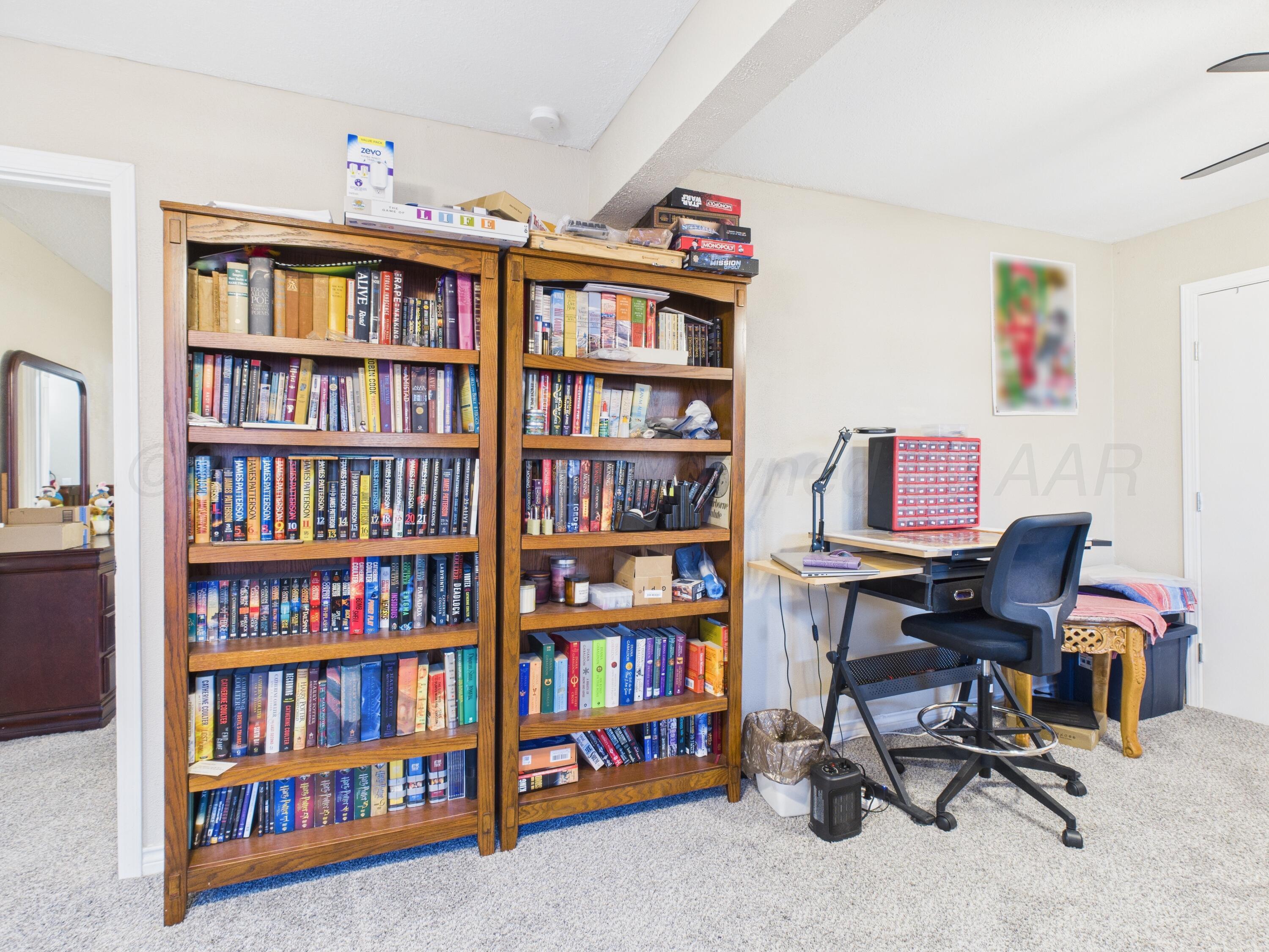 1816 Tularosa Street Amarillo, TX 79102 - Photo 22 of 24 a view of a workspace with bookshelf and a workspace