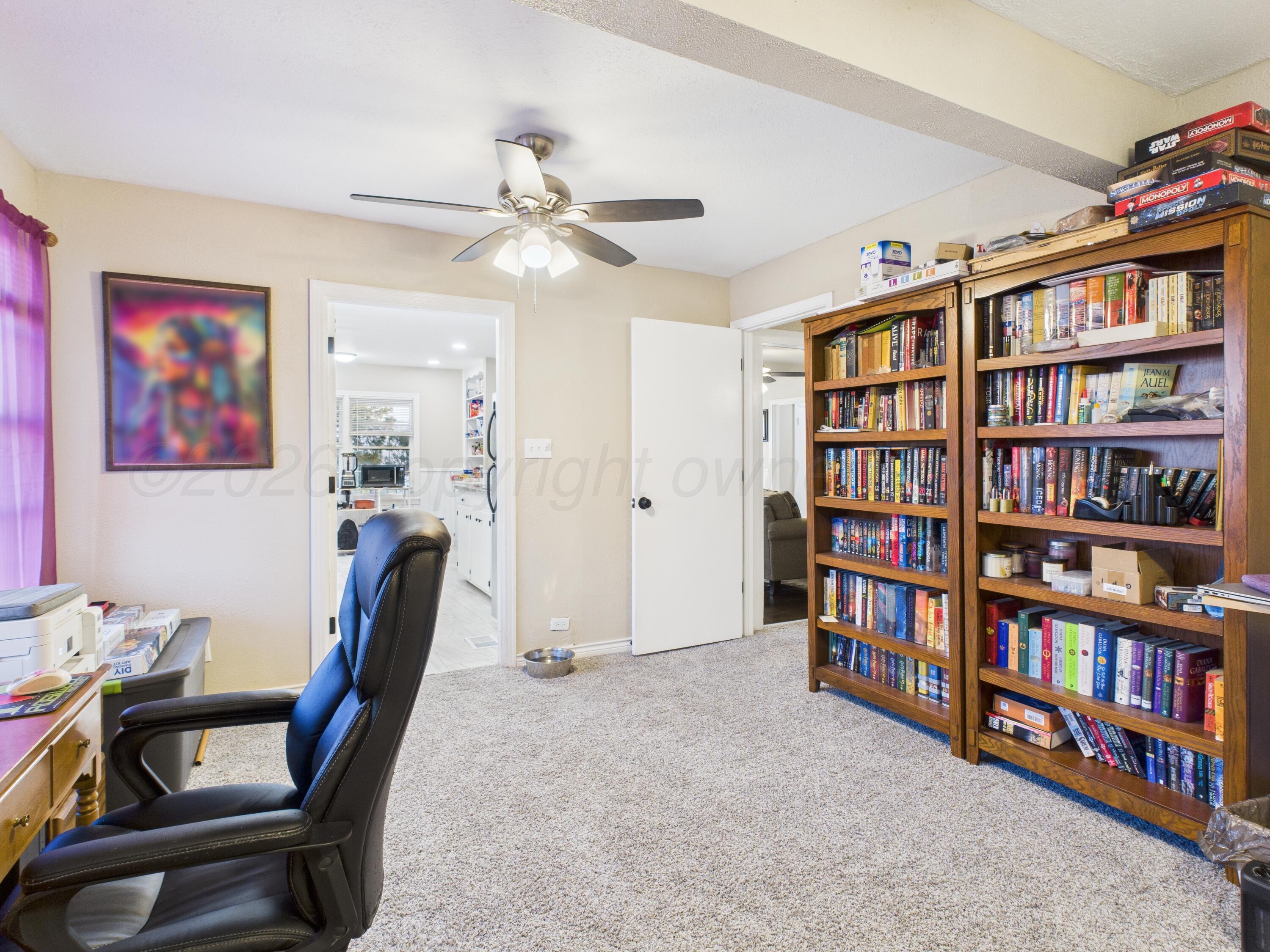 1816 Tularosa Street Amarillo, TX 79102 - Photo 23 of 24 a view of a workspace with furniture and book shelf