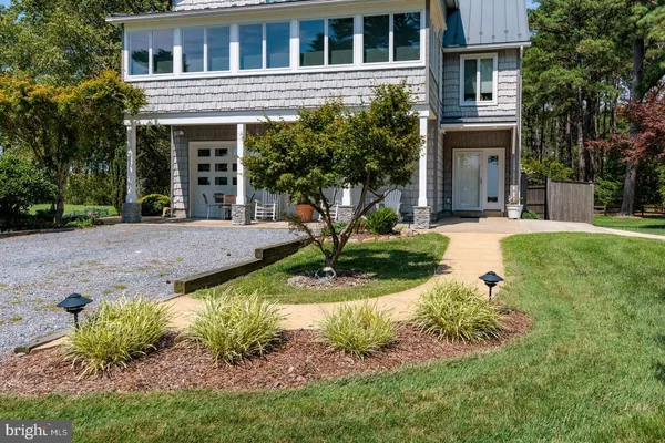 a front view of a house with garden