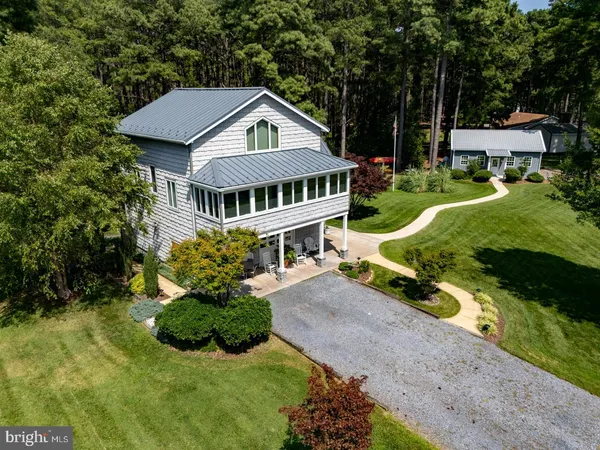 an aerial view of a house with yard and green space