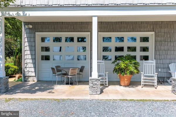 a view of a patio with table and chairs and potted plants