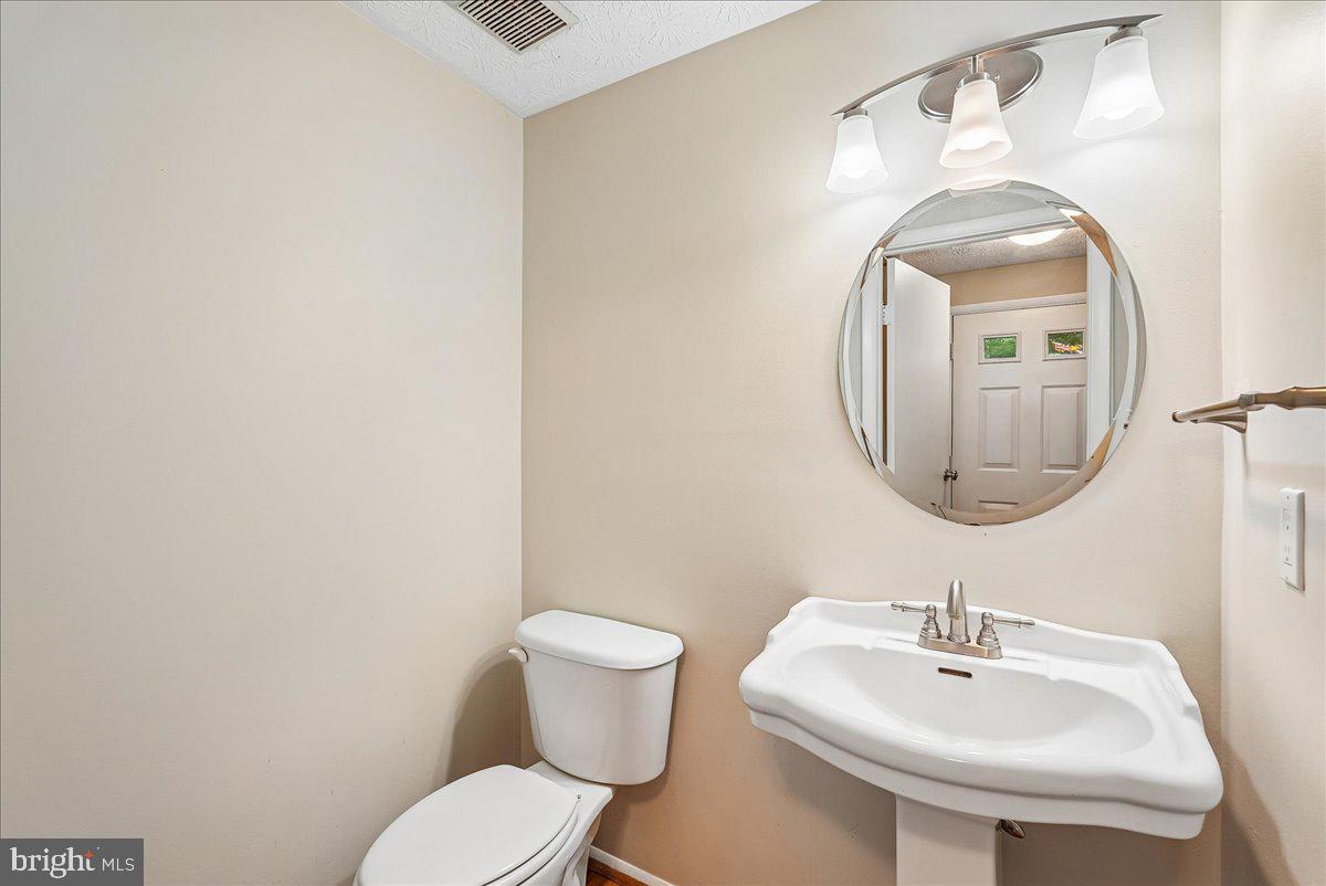 2331 Middle Creek Lane Reston, VA 20191 - Photo 24 of 78 a bathroom with a toilet sink and mirror