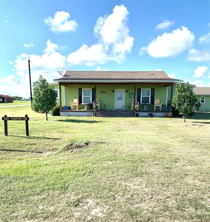 a view of a house with swimming pool and a yard