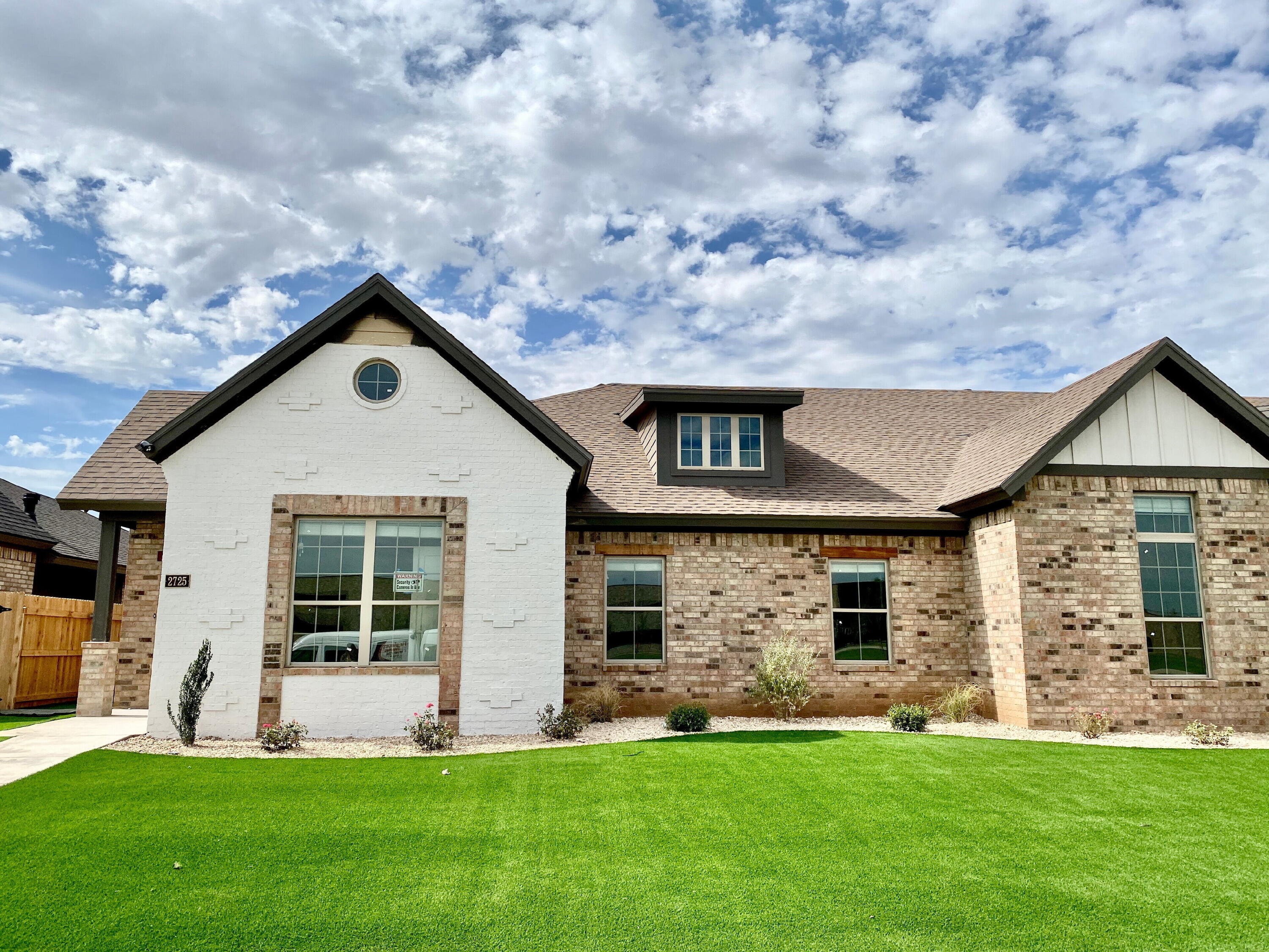 2725 137th Street Lubbock, TX 79423 - Photo 1 of 17 a front view of a house with a yard and garage