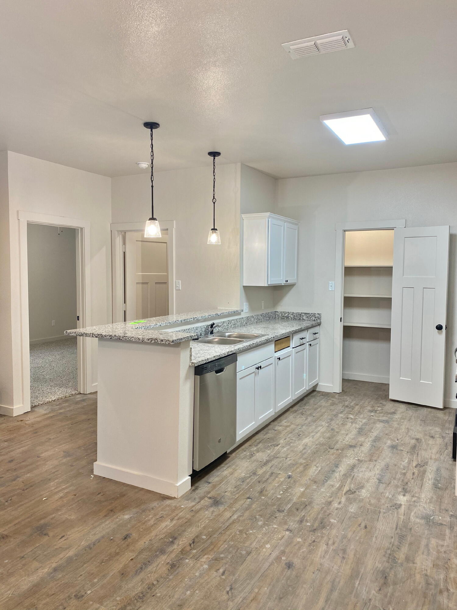 2725 137th Street Lubbock, TX 79423 - Photo 3 of 17 a large kitchen with kitchen island a sink stainless steel appliances and cabinets