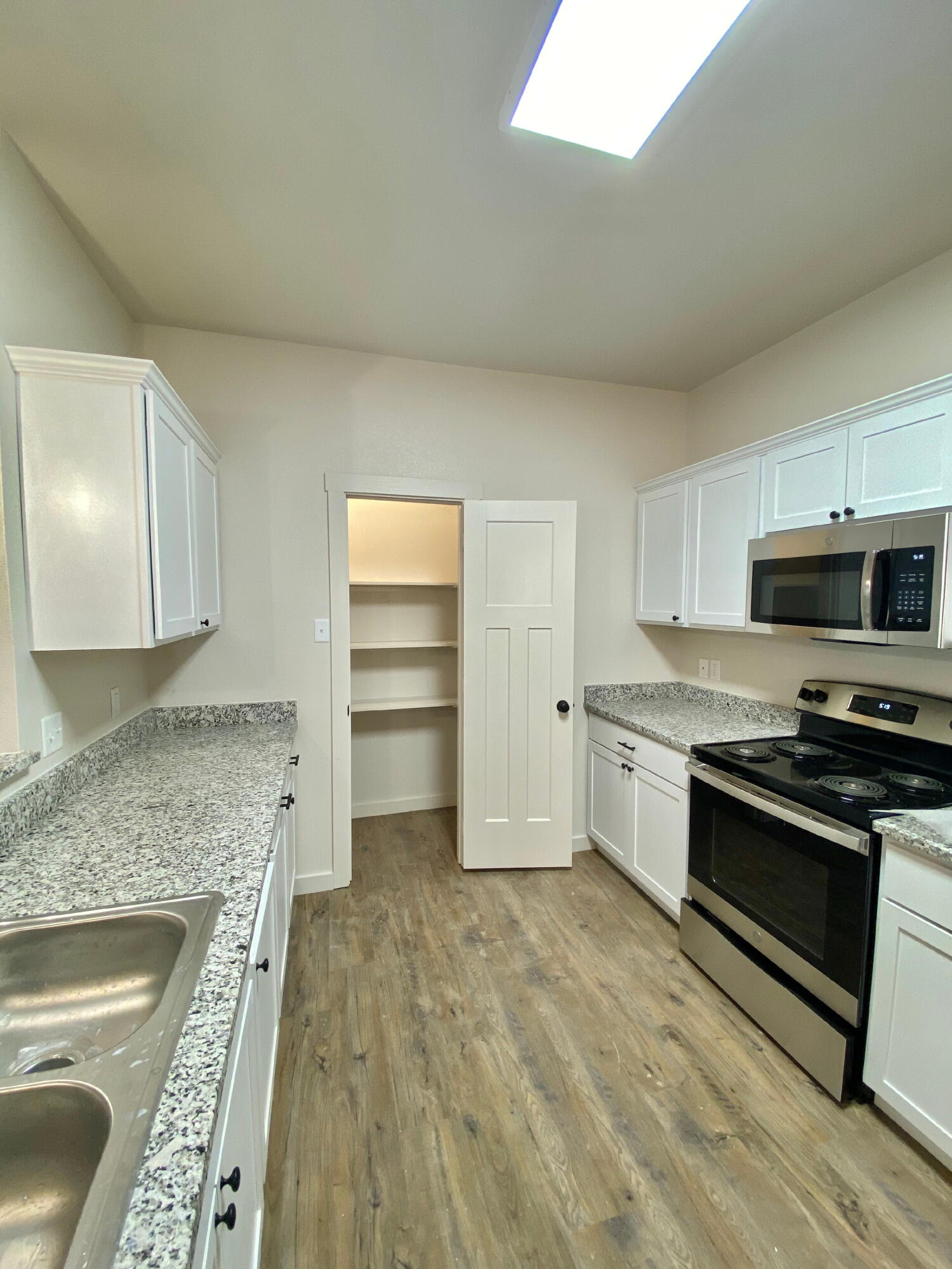 2725 137th Street Lubbock, TX 79423 - Photo 4 of 17 a kitchen with stainless steel appliances granite countertop a stove a sink and a refrigerator
