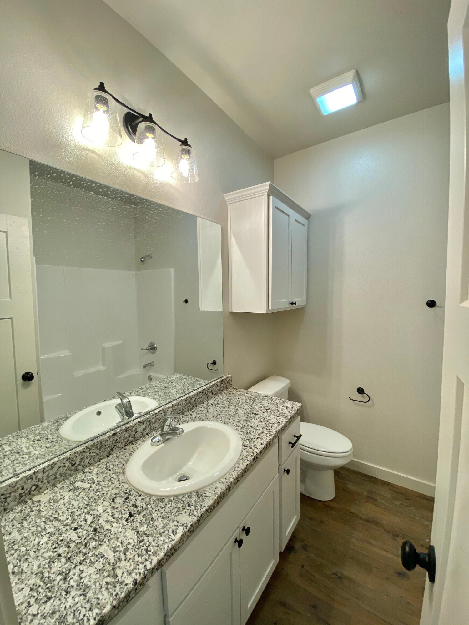 2725 137th Street Lubbock, TX 79423 - Photo 7 of 17 a bathroom with a granite countertop sink and a mirror