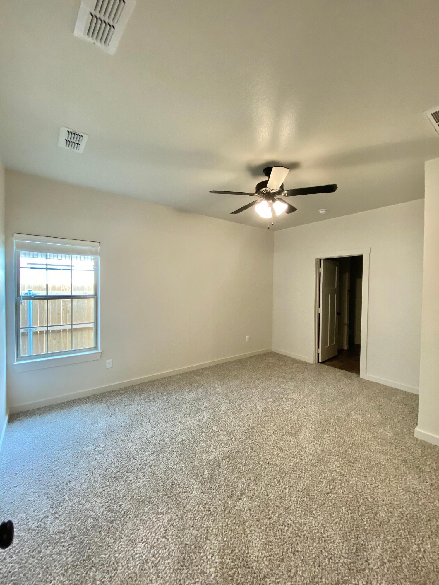 2725 137th Street Lubbock, TX 79423 - Photo 9 of 17 a view of a livingroom with a ceiling fan and window