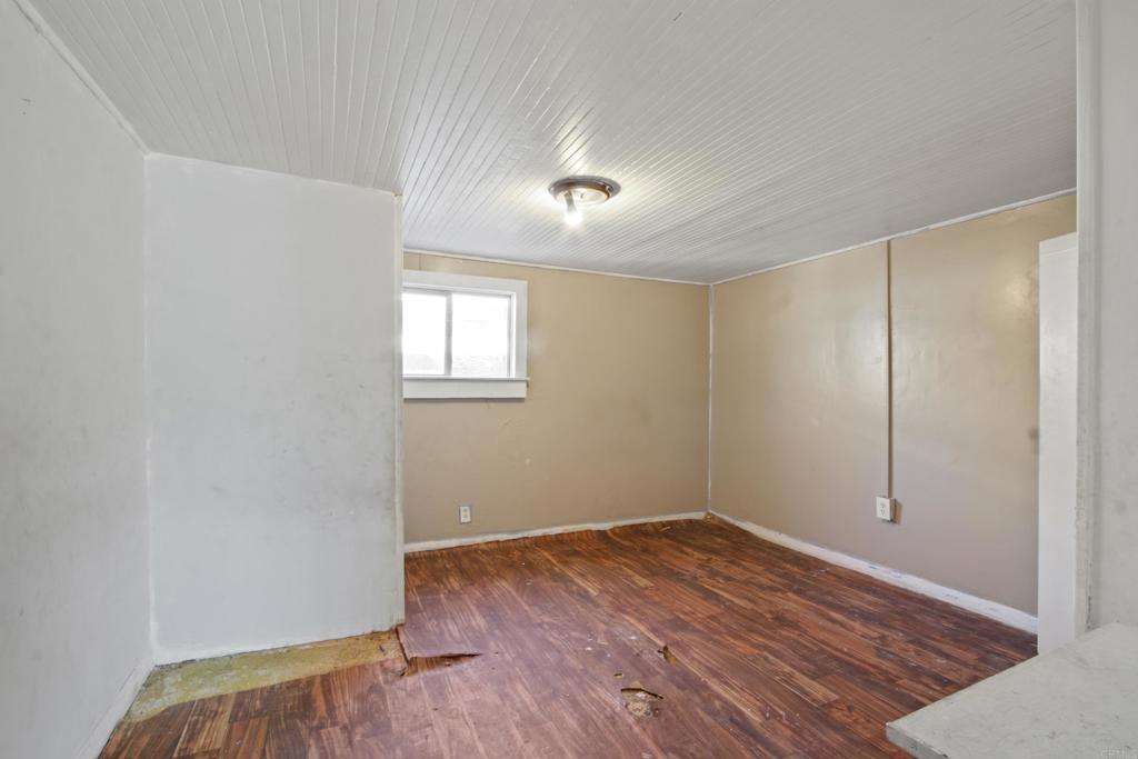 12940 Fourth Street Chino, CA 91710 - Photo 5 of 11 an empty room with wooden floor and windows