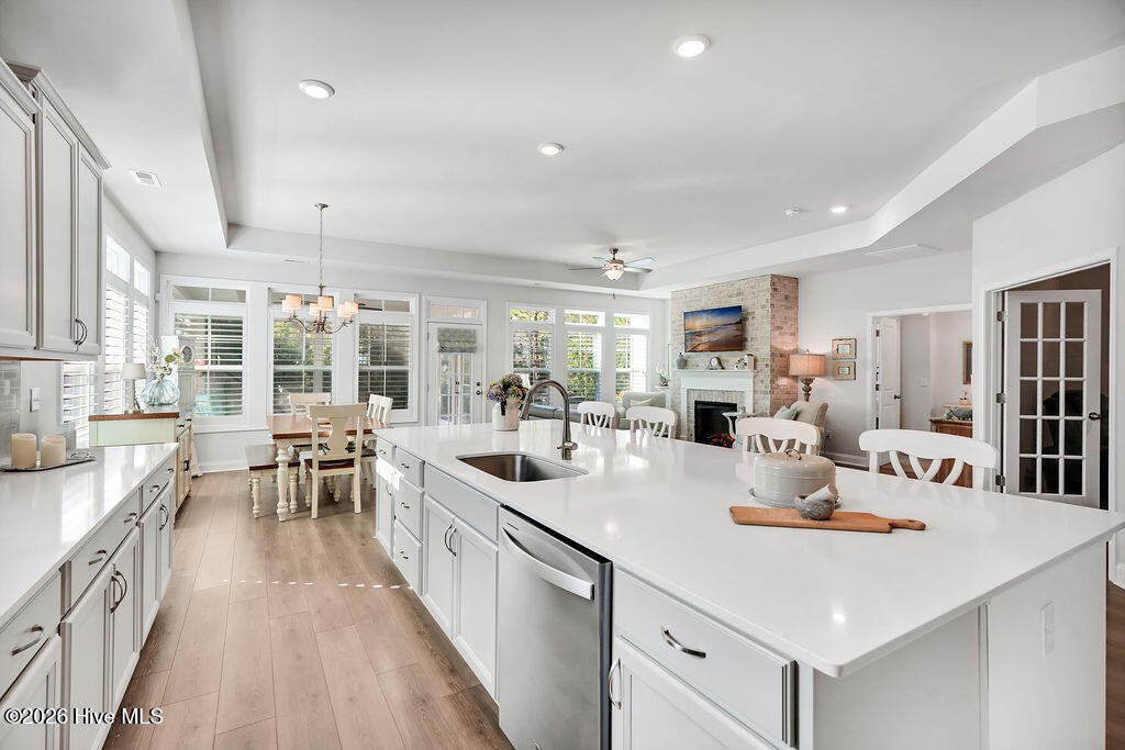 142 Rice Marsh Way Wilmington, NC 28412 - Photo 16 of 64 Chef-style kitchen island is the heart of this home and a natural gathering place. The kitchen also features upgraded premium staggered, color glazed cabinetry with dovetails, a single basin stainless sink, fully tiled backsplash throughout, upgraded stainless refrigerator and oven/range, upgraded granite countertops, brushed nickel lighting package, and custom plantation blinds.