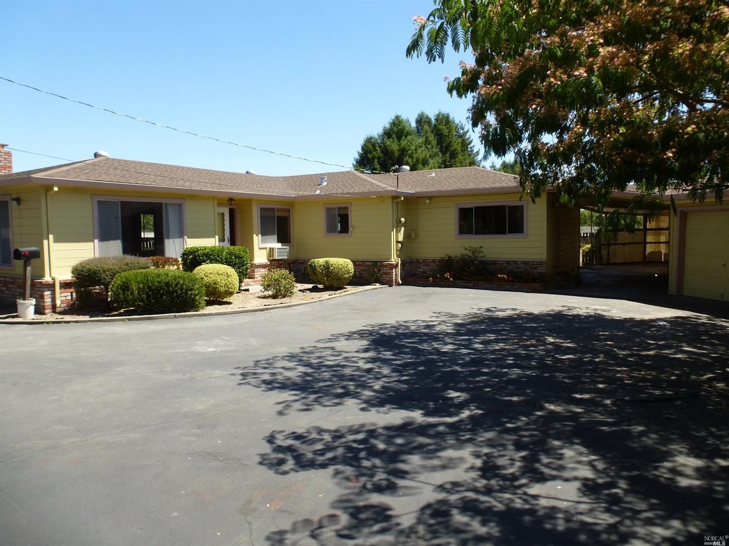 145 Bloomfield Road Sebastopol, CA 95472 - Photo 1 of 1 a front view of a house with a yard and a garage