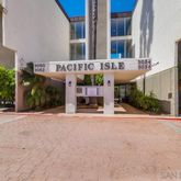 a front view of a building with small garden and plants