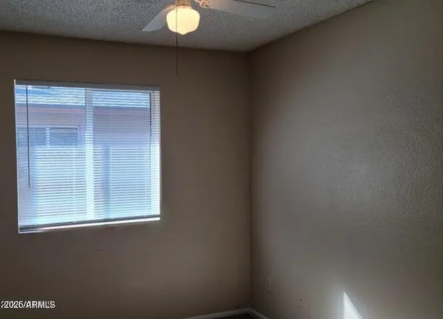 a view of a livingroom with a chandelier fan