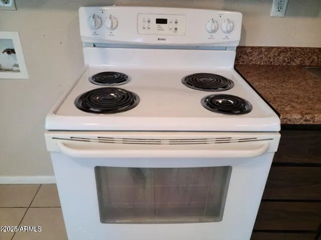 a white stove top oven sitting inside of a kitchen