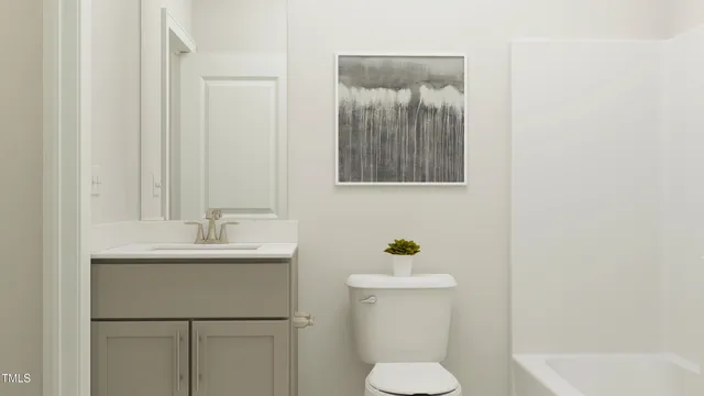 a bathroom with a sink toilet and mirror