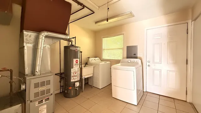a view of a storage and utility room with washer and dryer