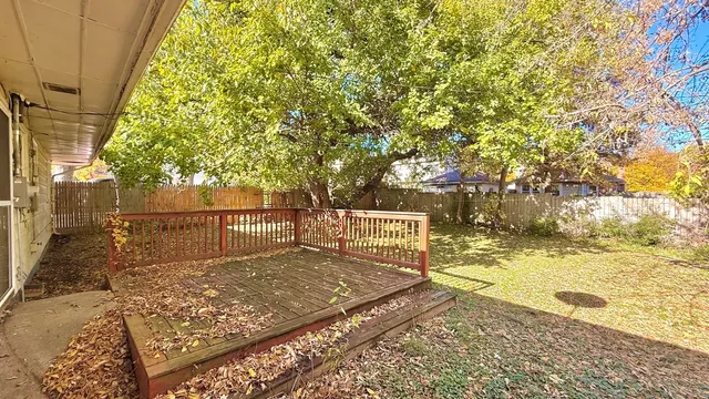 a sign board with yard in the back