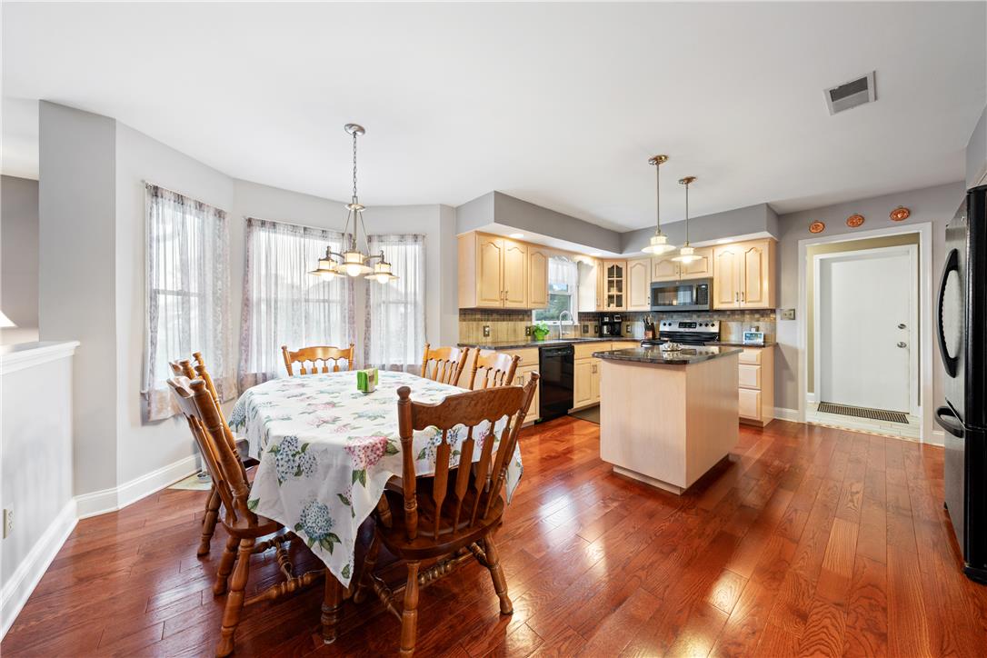 4568 Greenfield Road Bethlehem, PA 18017 - Photo 13 of 59 Hardwood floors and generous counter space define this inviting kitchen and dining area.