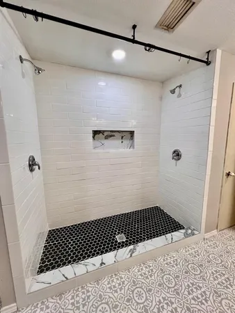 a kitchen with stainless steel appliances granite countertop a stove a sink a refrigerator and a black countertop
