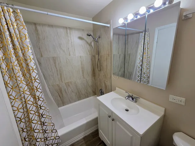 a bathroom with a sink toilet and shower