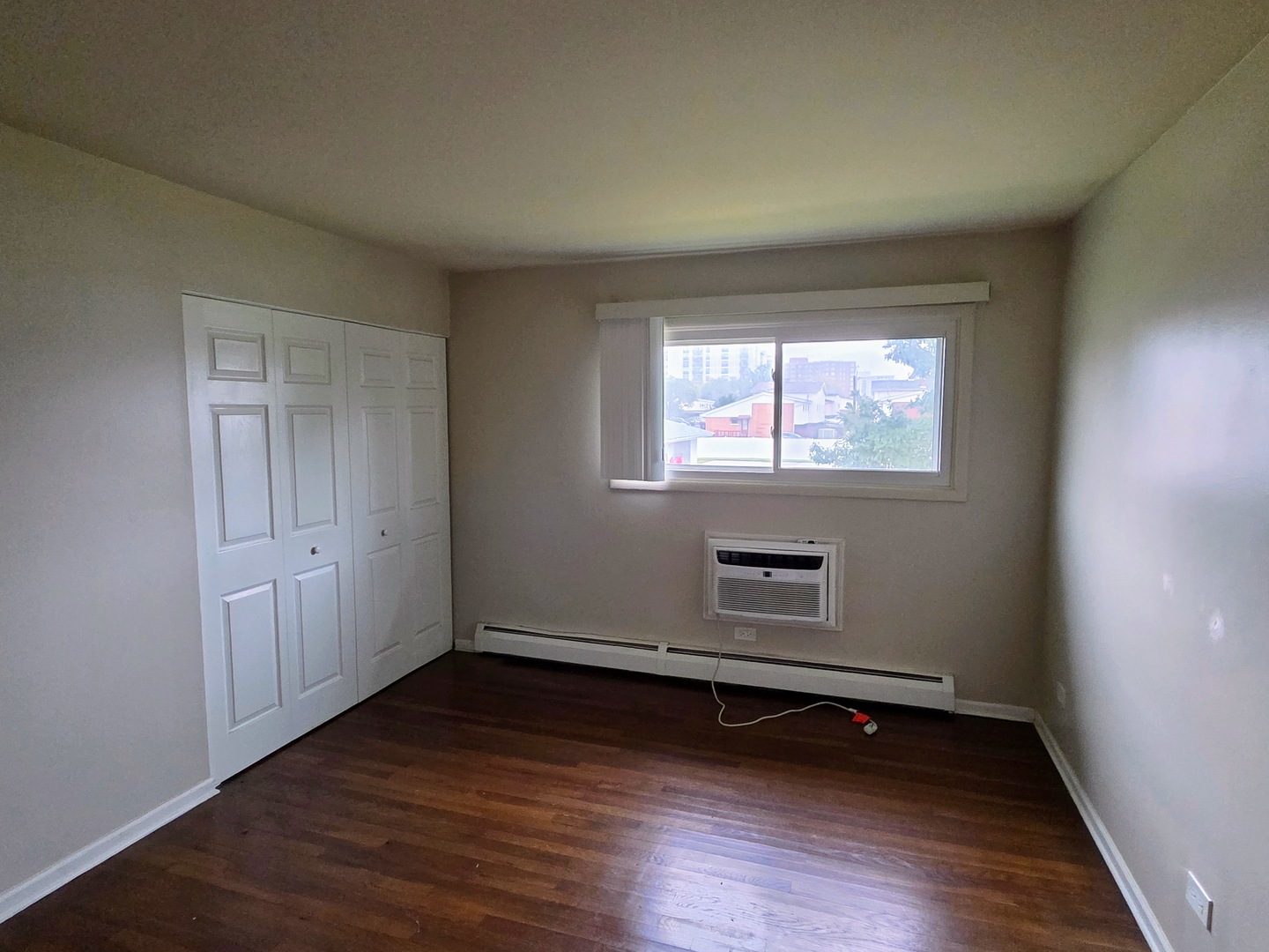 9561 Dee Road, Unit 2D Des Plaines, IL 60016 - Photo 7 of 9 an empty room with wooden floor and windows