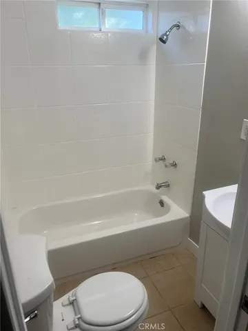 a bathroom with a toilet a sink and bathtub