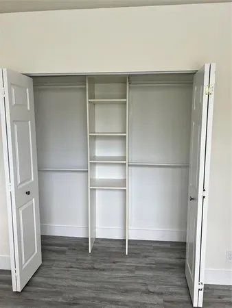 a view of walk in closet with empty racks